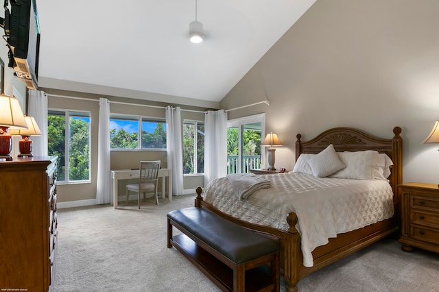 bedroom with light colored carpet and high vaulted ceiling