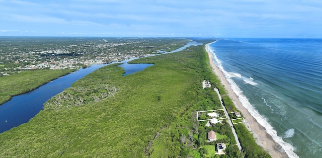 drone / aerial view featuring a water view and a beach view