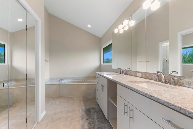 bathroom featuring vanity, independent shower and bath, vaulted ceiling, and plenty of natural light