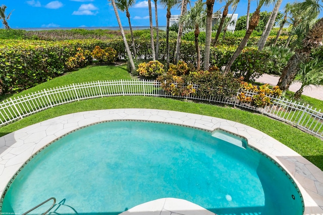 view of pool with a lawn