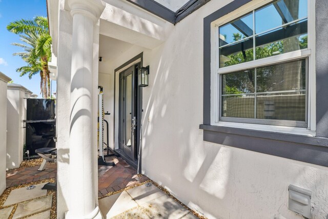 entrance to property with stucco siding