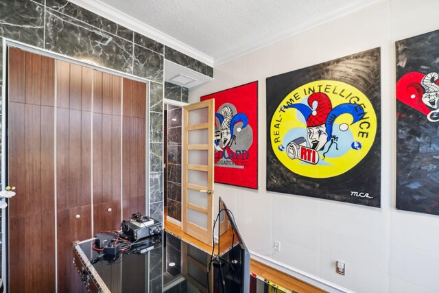 interior space featuring ornamental molding and a textured ceiling