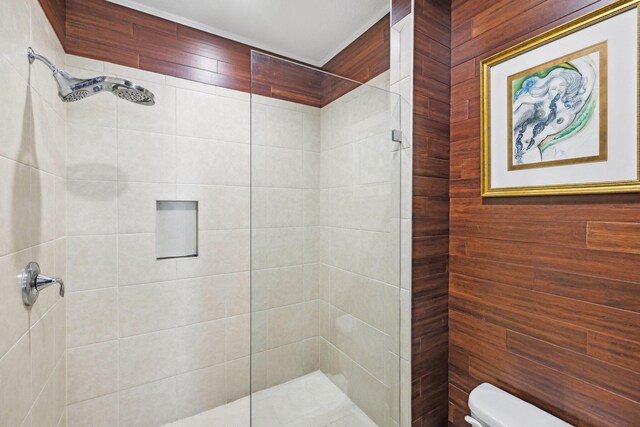 bathroom with tiled shower and toilet