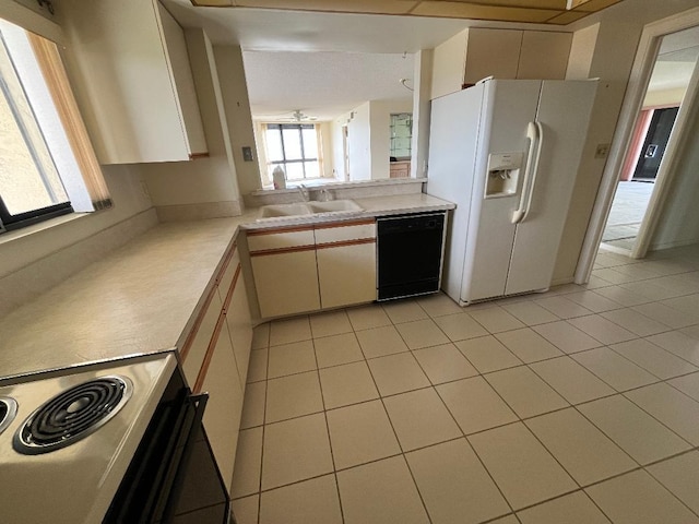 kitchen with stainless steel electric range oven, light tile patterned floors, dishwasher, white refrigerator with ice dispenser, and sink