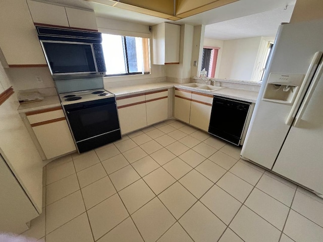 kitchen with dishwasher, white refrigerator with ice dispenser, sink, electric stove, and light tile patterned flooring