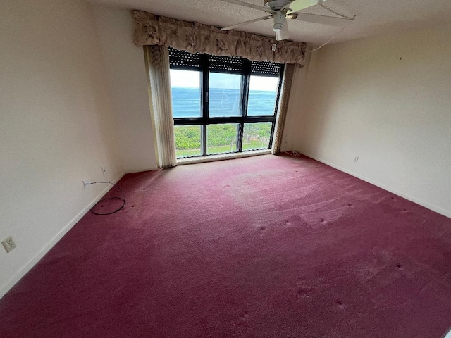 unfurnished room featuring carpet and ceiling fan