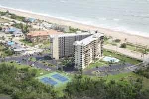 birds eye view of property with a view of the beach and a water view