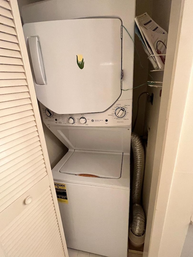 laundry area with stacked washer / dryer