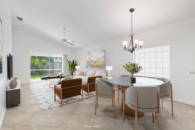 tiled dining space with lofted ceiling and ceiling fan with notable chandelier