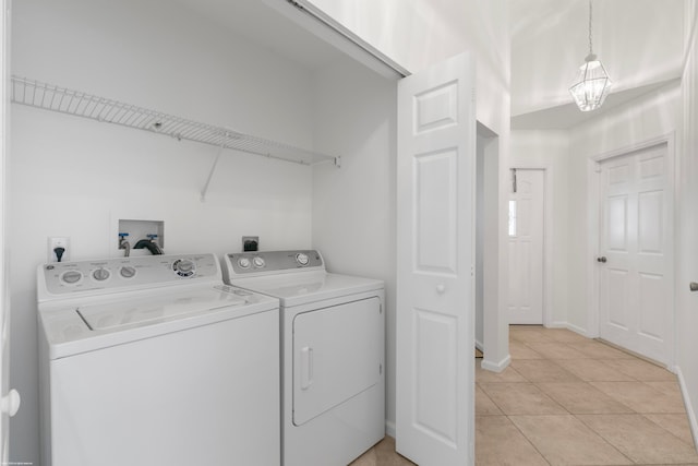 laundry area featuring separate washer and dryer and light tile patterned floors