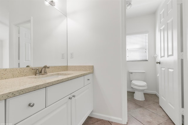 bathroom featuring vanity, toilet, and tile patterned floors