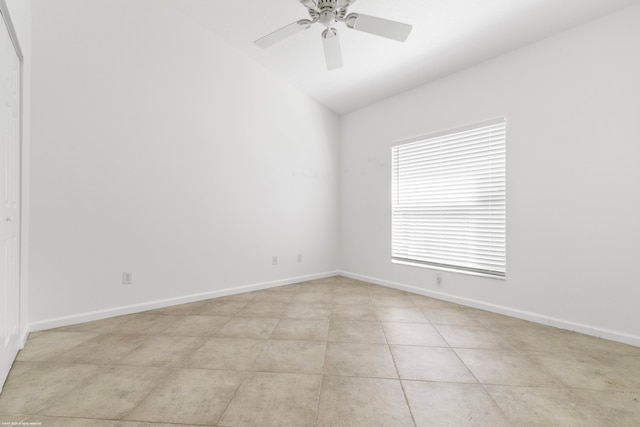 tiled spare room with lofted ceiling and ceiling fan