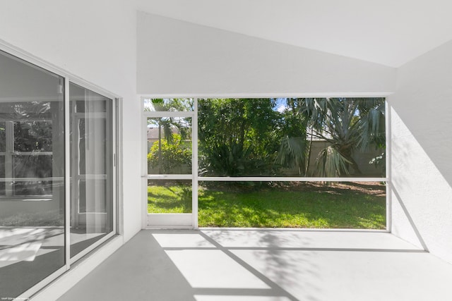 unfurnished sunroom featuring lofted ceiling