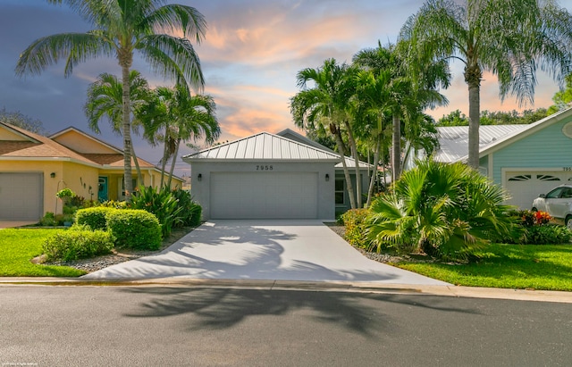 view of front of property with a yard and a garage