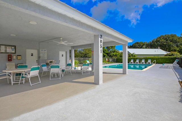 view of swimming pool with a patio area and ceiling fan