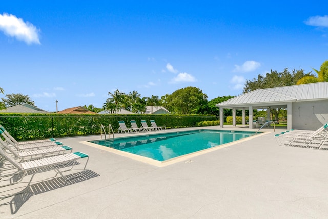 view of swimming pool with a patio