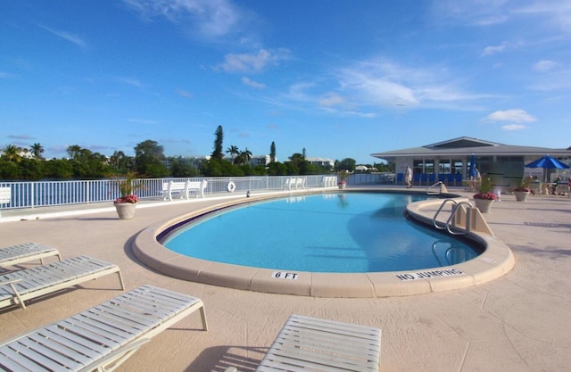 pool featuring a patio area and fence