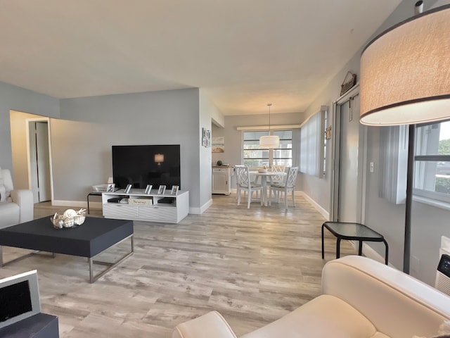 living room with light wood-style floors and baseboards