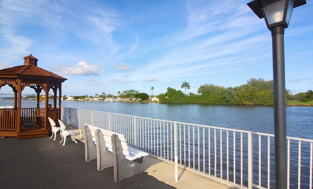 view of dock featuring a gazebo and a water view