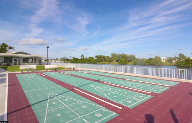 view of home's community with shuffleboard and fence