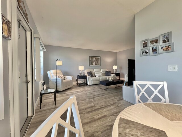 living room with baseboards and wood finished floors