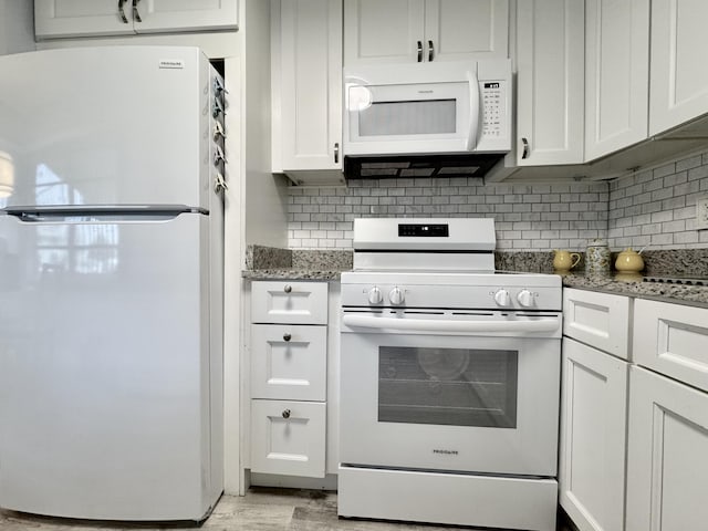 kitchen with stone counters, white appliances, white cabinetry, and decorative backsplash