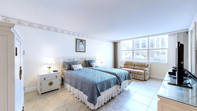 bedroom with a textured ceiling and light tile patterned floors