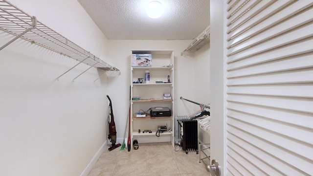 spacious closet featuring light tile patterned floors