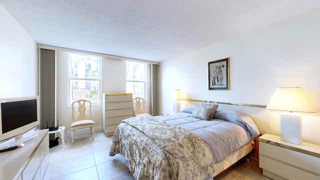 tiled bedroom featuring a textured ceiling