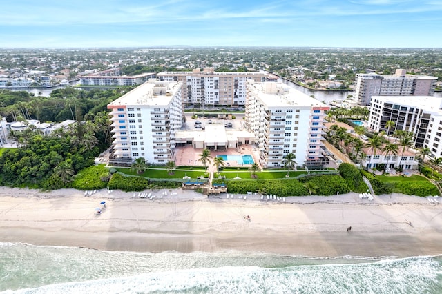 birds eye view of property with a water view and a view of the beach