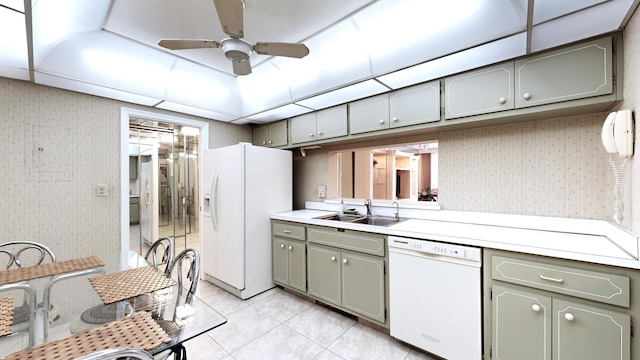 kitchen featuring gray cabinetry, a sink, wallpapered walls, and white appliances