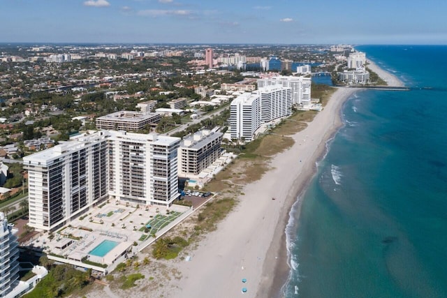 bird's eye view featuring a water view and a beach view