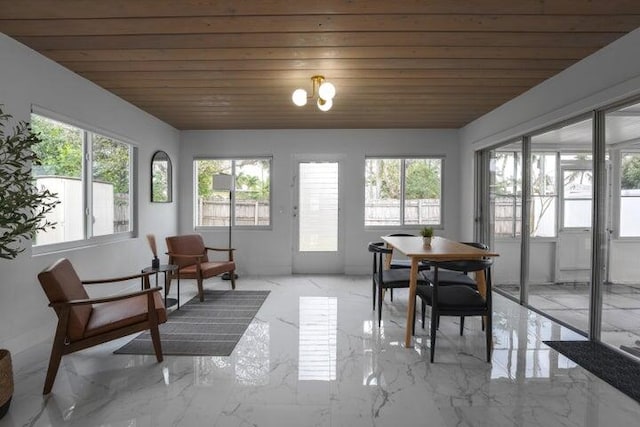 sunroom featuring wooden ceiling and a wealth of natural light