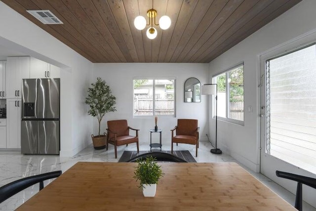 tiled dining space featuring wood ceiling and a healthy amount of sunlight