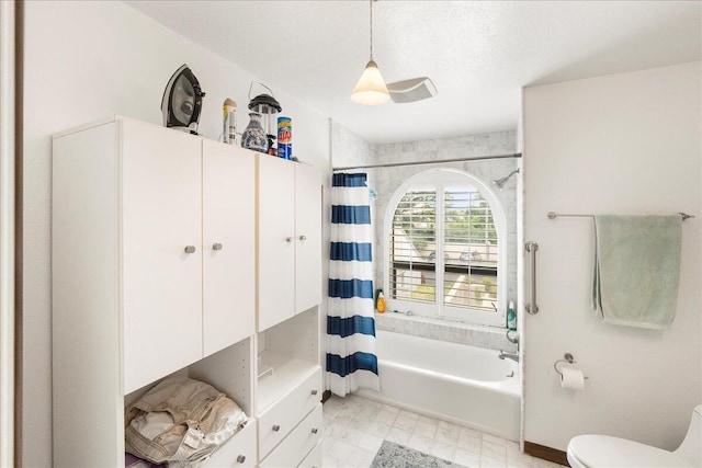 bathroom featuring toilet, a textured ceiling, and shower / tub combo with curtain