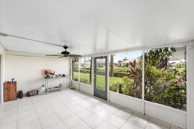 unfurnished sunroom featuring ceiling fan