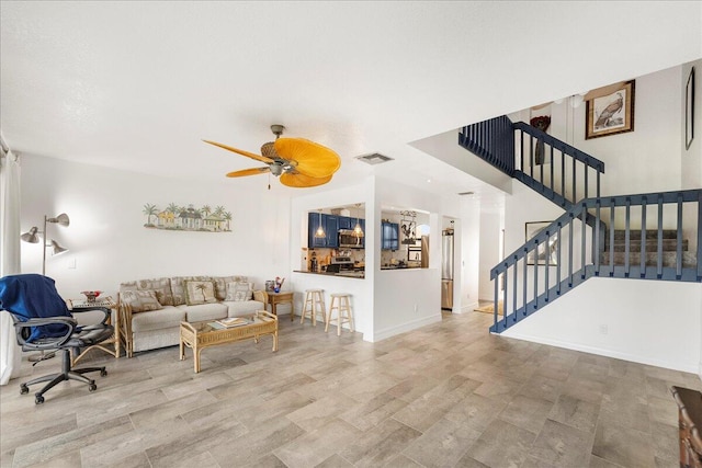 living room featuring ceiling fan and light hardwood / wood-style floors