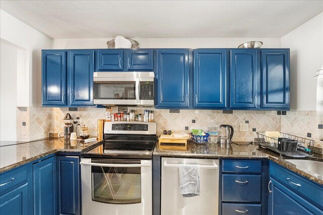 kitchen with backsplash, stainless steel appliances, and blue cabinets