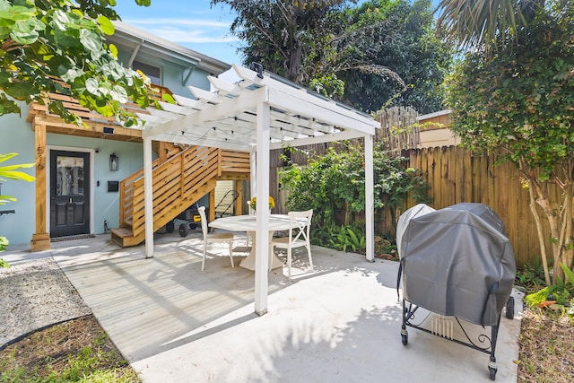 view of patio / terrace with area for grilling and a pergola