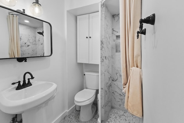 bathroom featuring sink, toilet, and walk in shower