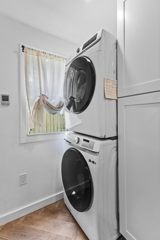 washroom with stacked washer and dryer