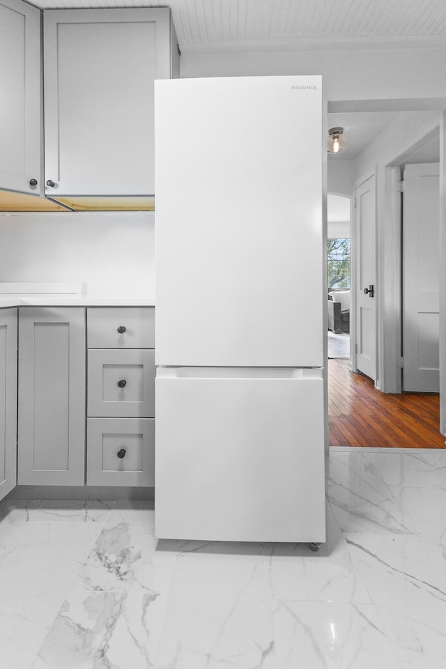 details featuring gray cabinets, wooden ceiling, light hardwood / wood-style floors, and white refrigerator