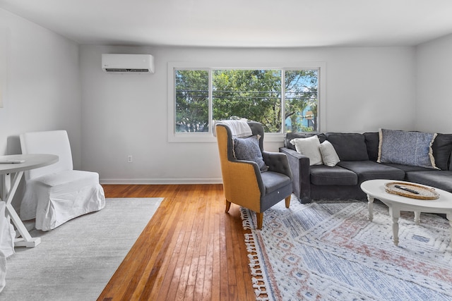 living room featuring hardwood / wood-style floors and a wall mounted air conditioner