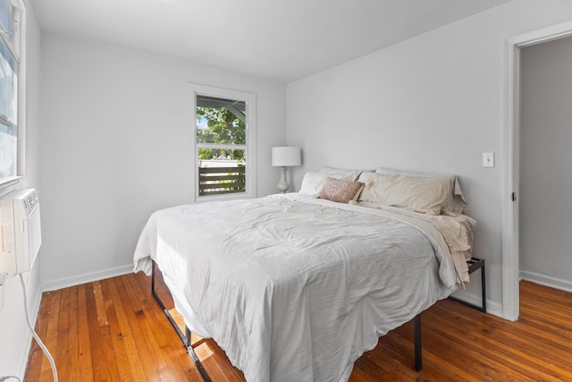 bedroom with dark hardwood / wood-style flooring