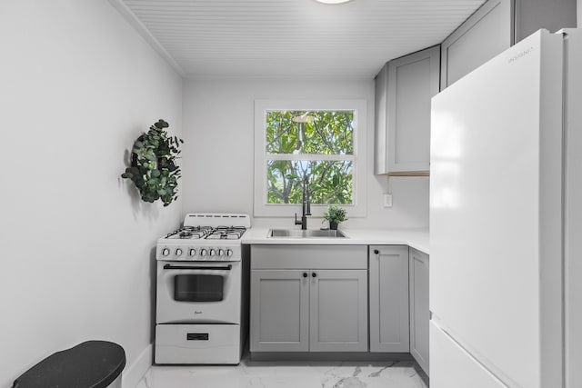 kitchen with gray cabinets, sink, and white appliances