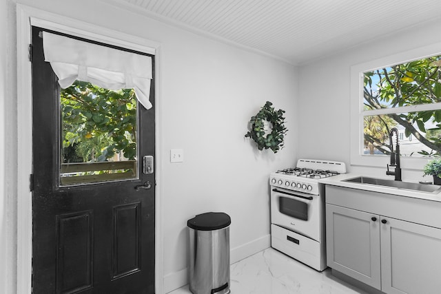 kitchen featuring sink, white range with gas cooktop, and gray cabinetry