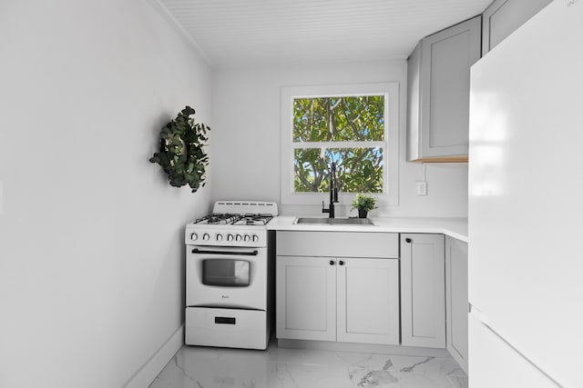 kitchen featuring white appliances, sink, and gray cabinets