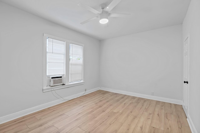 unfurnished room featuring cooling unit, ceiling fan, and light wood-type flooring