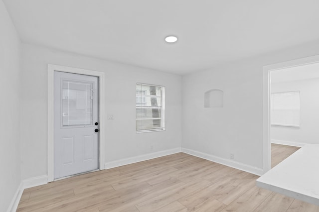 empty room with light hardwood / wood-style flooring