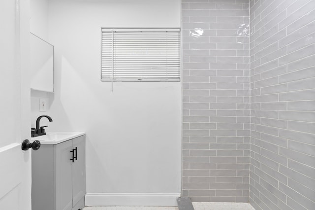 bathroom featuring vanity and a tile shower